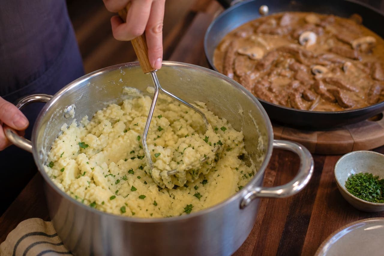 Creamy Beef Stroganoff with Mushrooms and Herby Mash cooking step 5: Mash with parsley.