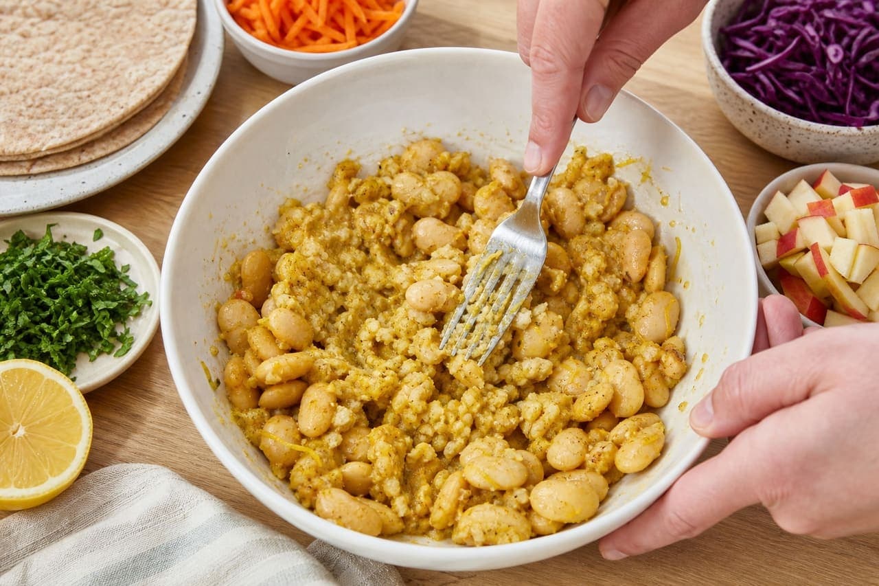 Curried Butter Bean Apple Wraps with Crunchy Carrot Slaw cooking step 3: Crush the butter beans.
