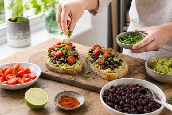 Smoky Avocado Black Bean Breakfast Toasts with Tomato cooking step 5: Build the toasts.