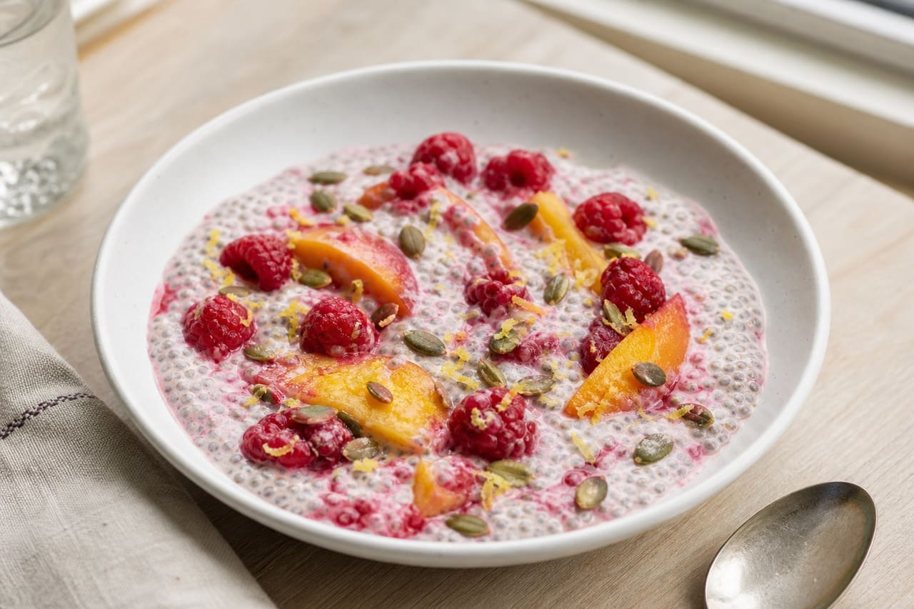 Raspberry Peach Chia Breakfast Pots with Lemon and Pumpkin Seeds.